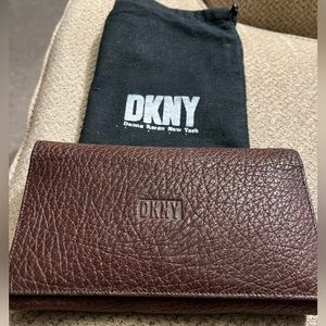 DKNY chocolate brown wallet with dust cover. One small wear mark..see pi…